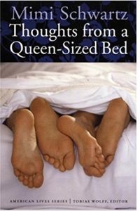 Two pairs of feet under a blanket